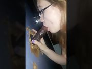 Sucking a black cock through a gloryhole tasting his cum